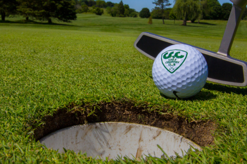 golf ball near hole on course